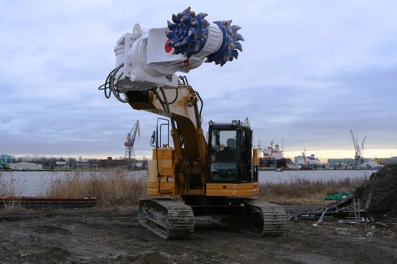 Excavator with rotary drum cutter attachment