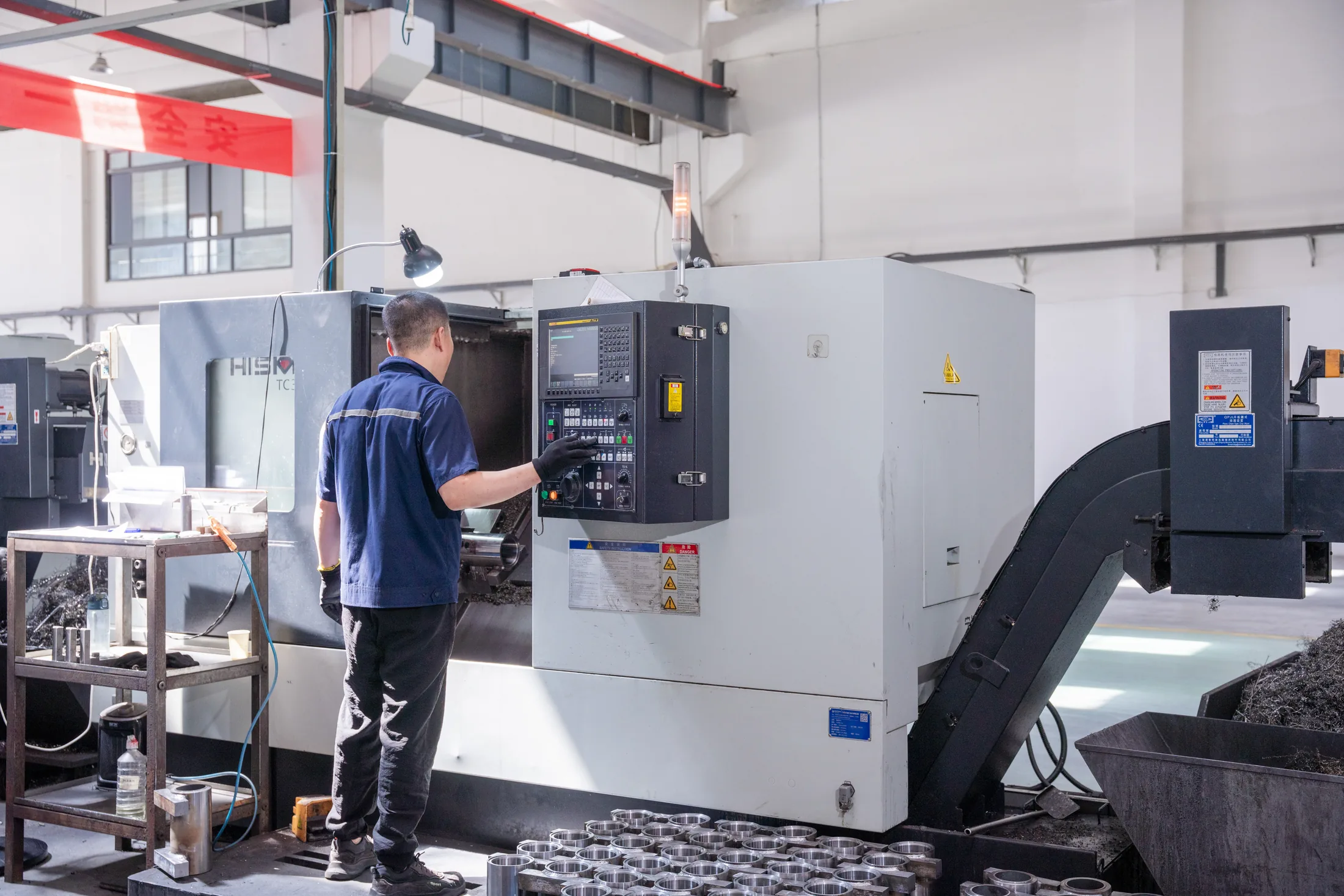 Operator running Hision CNC lathe